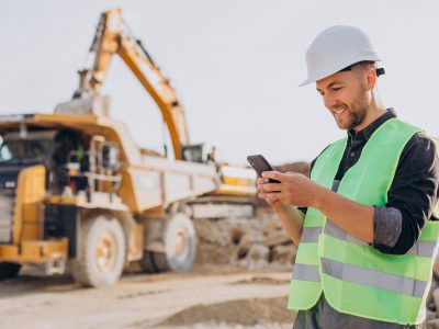 Male worker with bulldozer in sand quarry